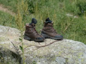 Brown hiking boots on a rock for a road trip