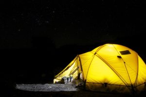 A yellow tent in night for a road trip