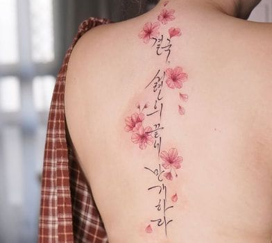 cherry blossoms spine tattoo for women 