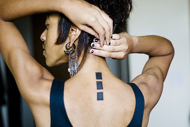 Square spine tattoo for women 