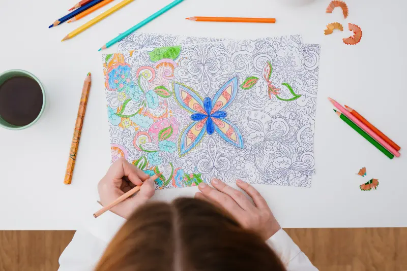 young lady enjoying adult coloring book one of favorite hobbies for women