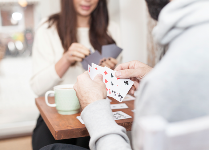 One of her favorite hobbies for women is playing card games, and she can be seen joyfully enjoying a game with her mate.