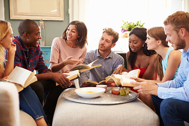 A group of friends taking part in book club at home one of favorite hobbies for women