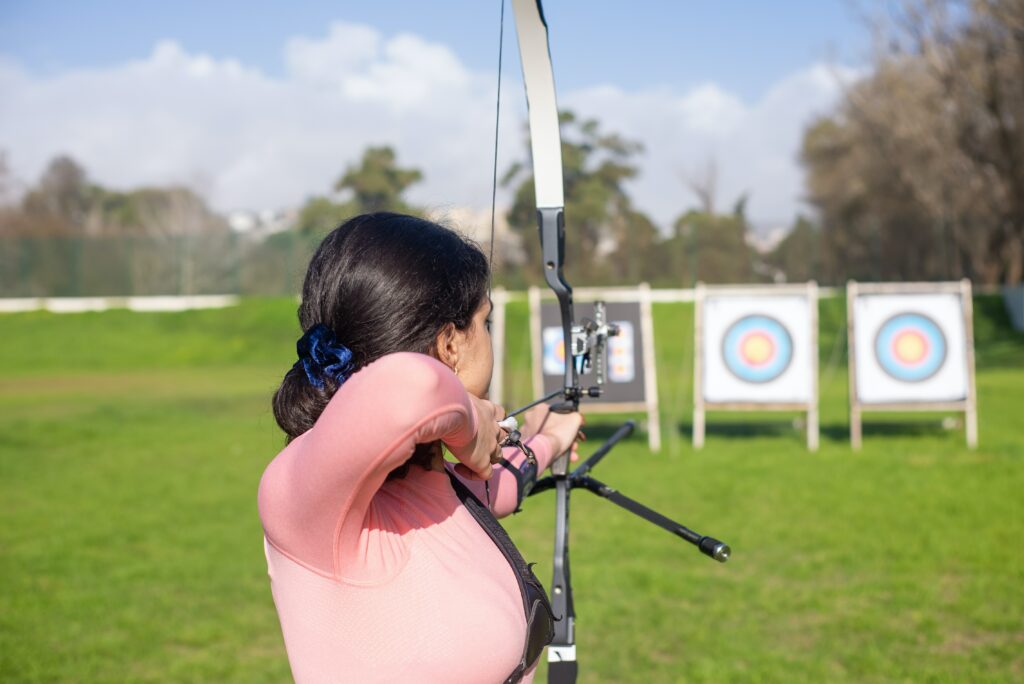 young lady practicing archery at range which is one of best hobbies for women 