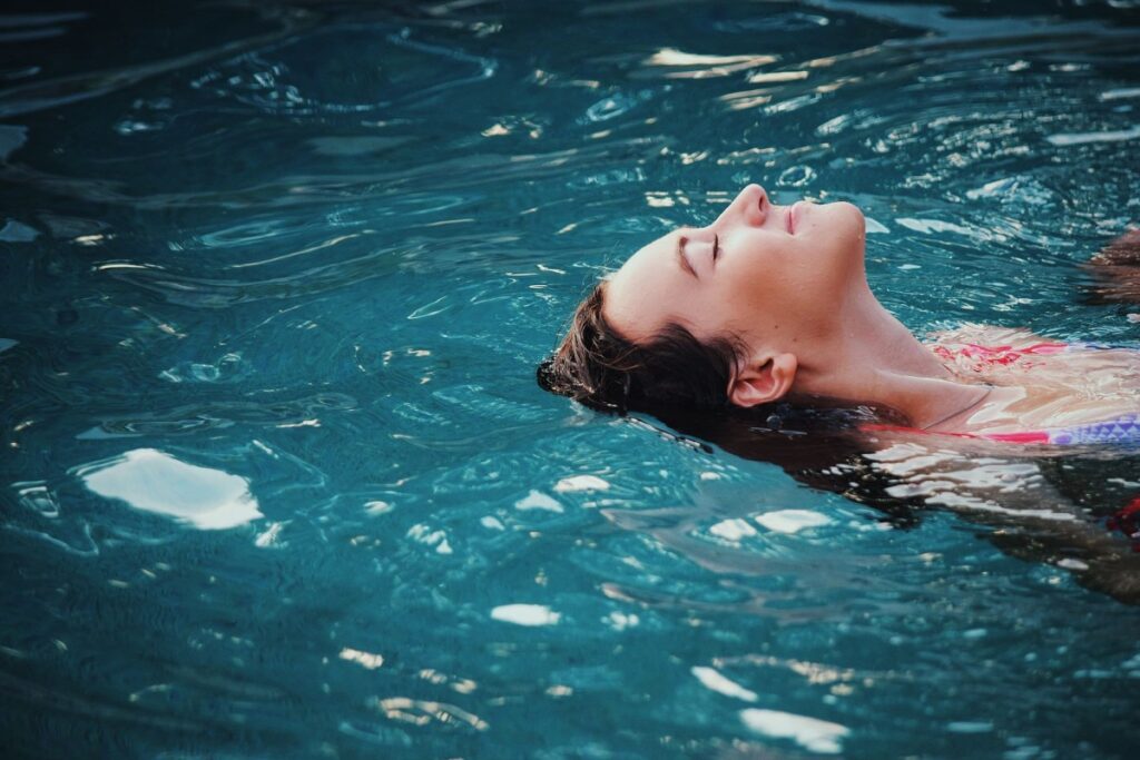 women relaxing in swimming pool doing one of her favorite hobbies for women