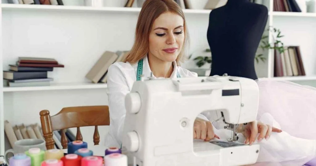 women sewing on sewing machine in her own boutique which is one of favorite hobbies for women