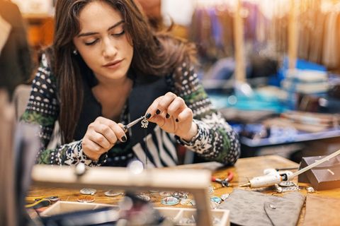 women is making jewellery in her own workplace which is one of favorite hobbies for women