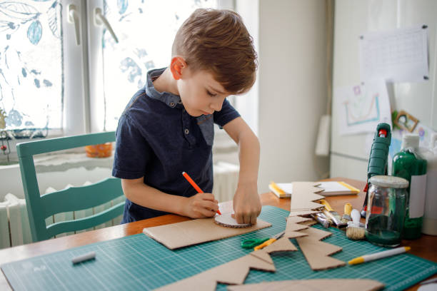 Photo of a boy making crafts - one of the great jobs for 8 year olds